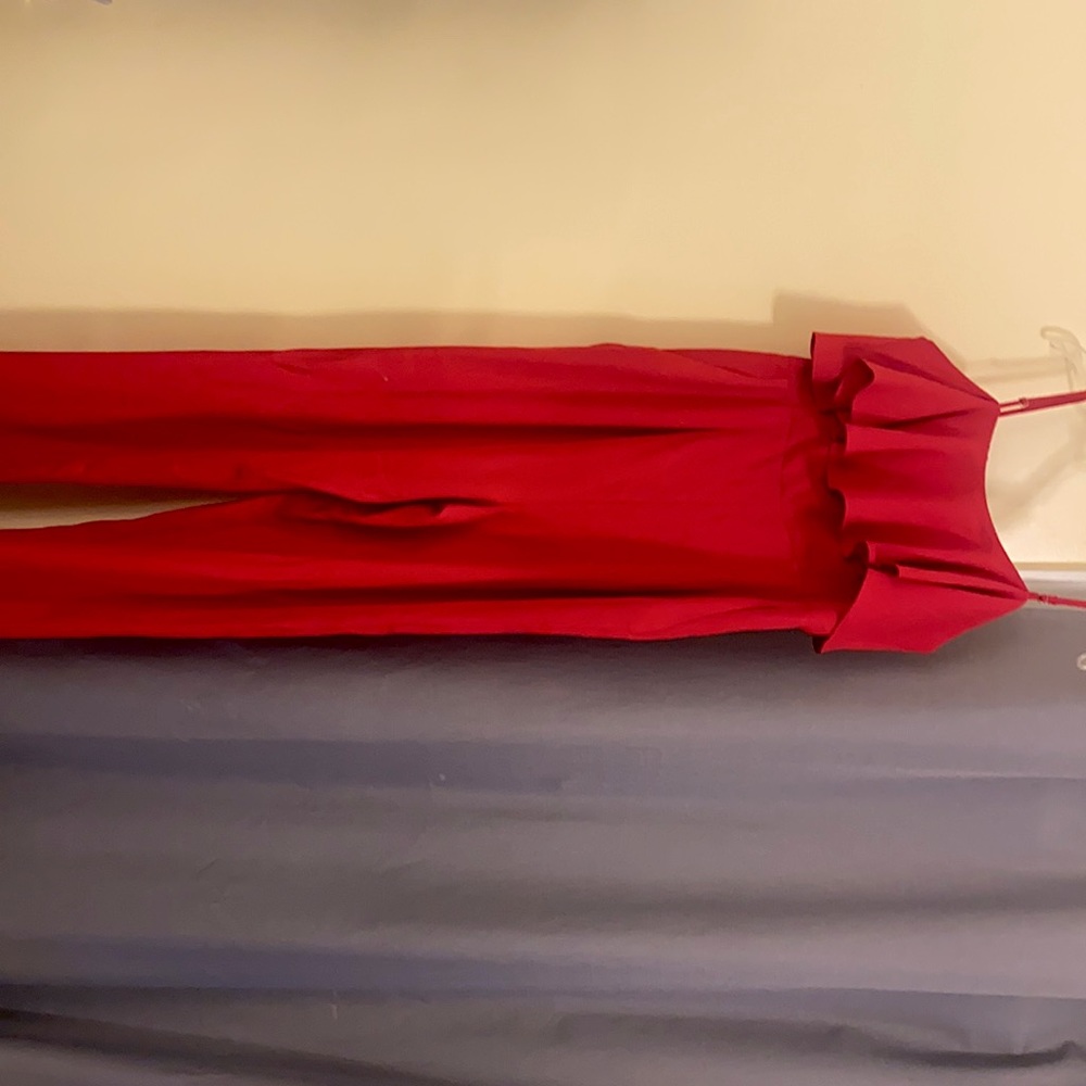 Red, adjustable spaghetti strap jumpsuit size M. Never worn, in new condition